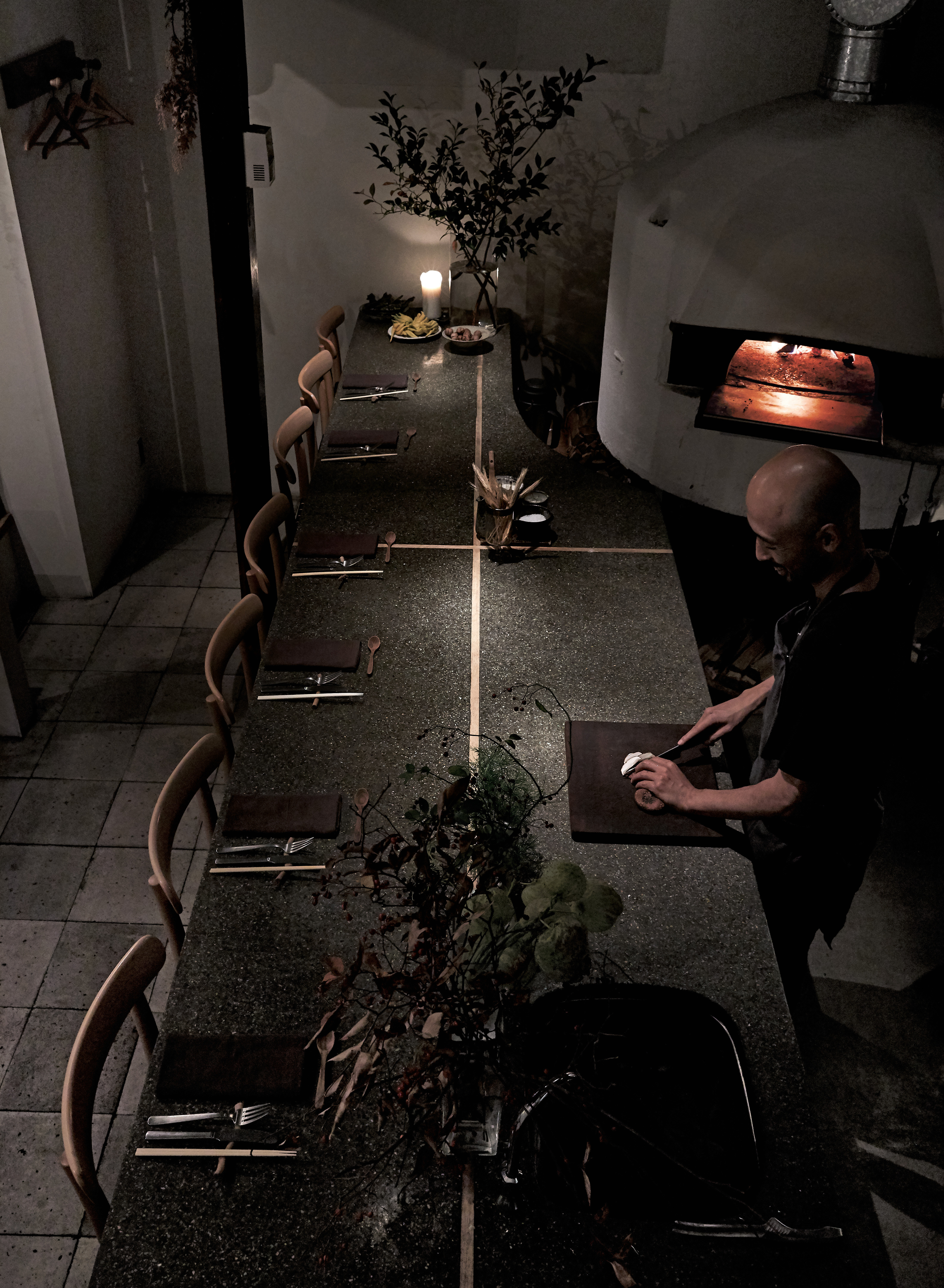 Yoshihiro Imai at monk, beside his floral arrangements. Photography Yuka Yanazume