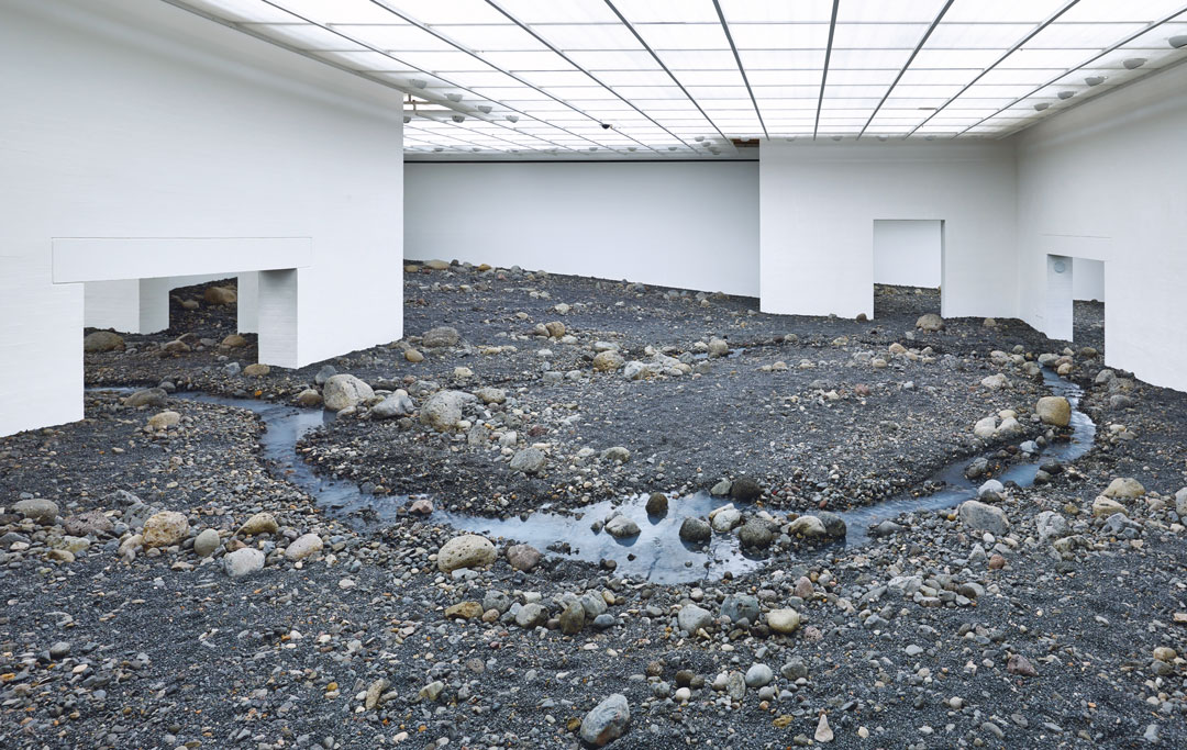 Riverbed, 2014, water, Icelandic rock (volcanic stones [blue basalt, basalt, lava], other stones, gravel, sand), wood, steel, plastic sheeting, hose, pumps, cooling unit, dimensions variable, installation views at Louisiana Museum of Modern, Art, Humlebæk, Denmark, 2014. Picture credit: Anders Sune Berg