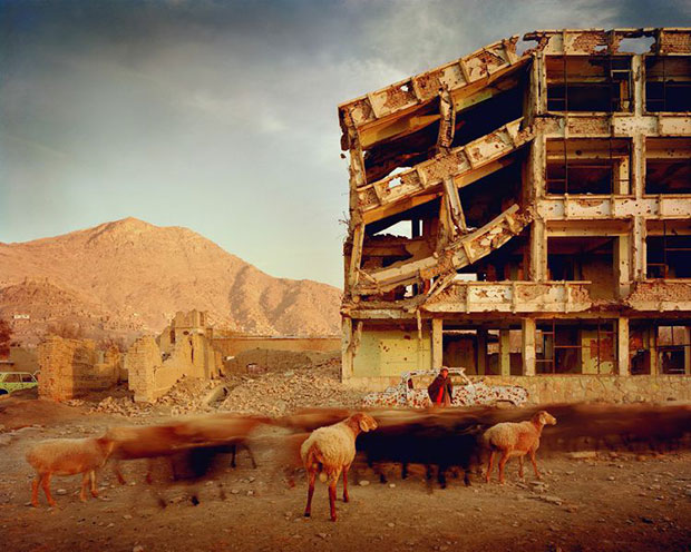 Simon Norfolk Bullet-scarred apartment building and shops in the Karte Char district of Kabul. This area saw fighting between Hikmetyar and Rabbani and then between Rabbani and the Hazaras  2003 © Simon Norfolk
