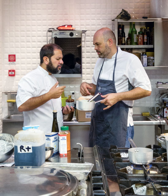 Enrique Olvera (left) with Carlos García at Massimo Bottura's Refettorio Ambrosiano. All images from Bread is Gold