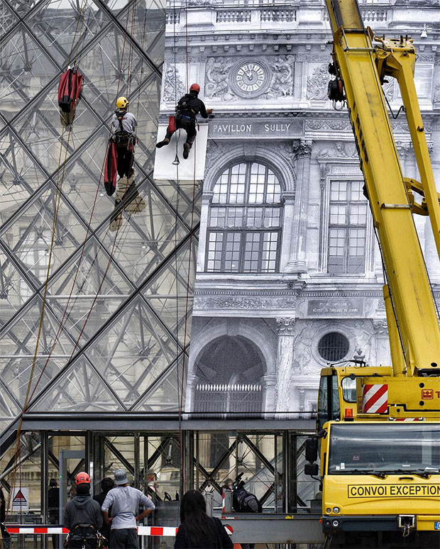 R's work being pasted up at the Louvre. Image courtesy of JR's Instagram