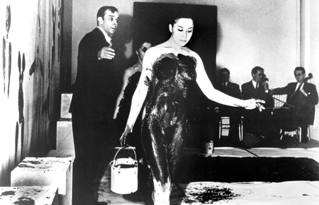 Yves Klein and model during a perfomance of Anthropométries de l’époque bleue, Paris, 1960