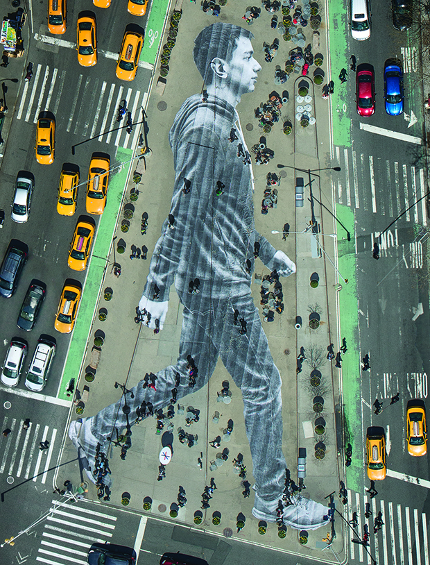 JR’s huge street portrait of Elmar Aliyev, a 20-year-old waiter from Azerbaijan, which served as the New York Times Magazine’s cover back in April 2015