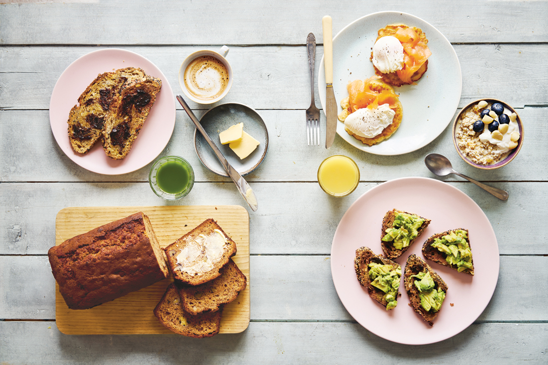 Clockwise From top left: toast with Vegemite; flat white; corn fritters with lox and poached eggs; muesli; ginger-turmeric juice; toast with Vegemite and avocado; banana bread; green juice. As featured on the Australian breakfast pages of Breakfast: The Cookbook 