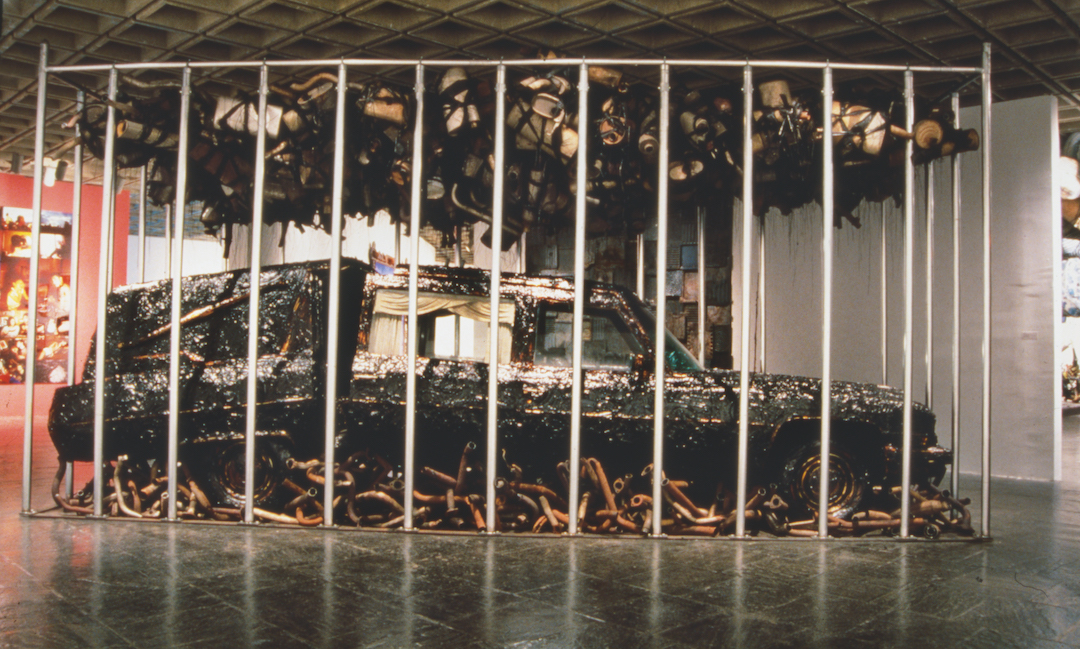 Nari Ward, Peace Keeper, 1995. Hearse, grease, mufflers, and feathers, 144 x 116 x 264 in (365.8 x 294.6 x 670.6 cm). Installation views: Whitney Museum of American Art, New York, 1995. Courtesy the artist, Lehmann Maupin, New York, Hong Kong, and Seoul, and Galleria Continua, San Gimignano, Beijing, Les Moulins, and Havana