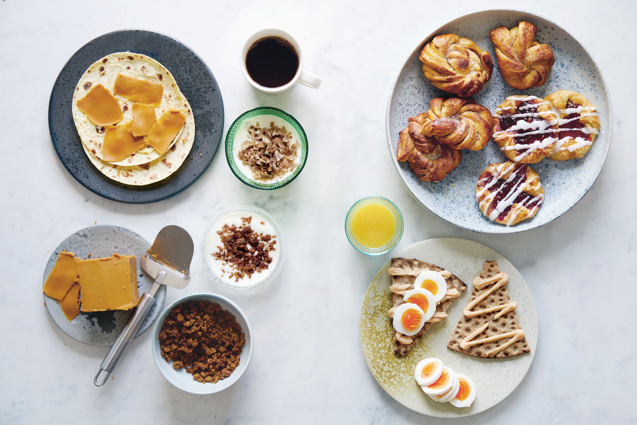 Clockwise from top left: Brown cheese sandwich; filmjölk; Danish pastry; cardamom buns; crispbread with smoked cod roe spread; ymerdrys; ymer with ymerdrys; all from the Nordic pages of Breakfast: The Cookbook