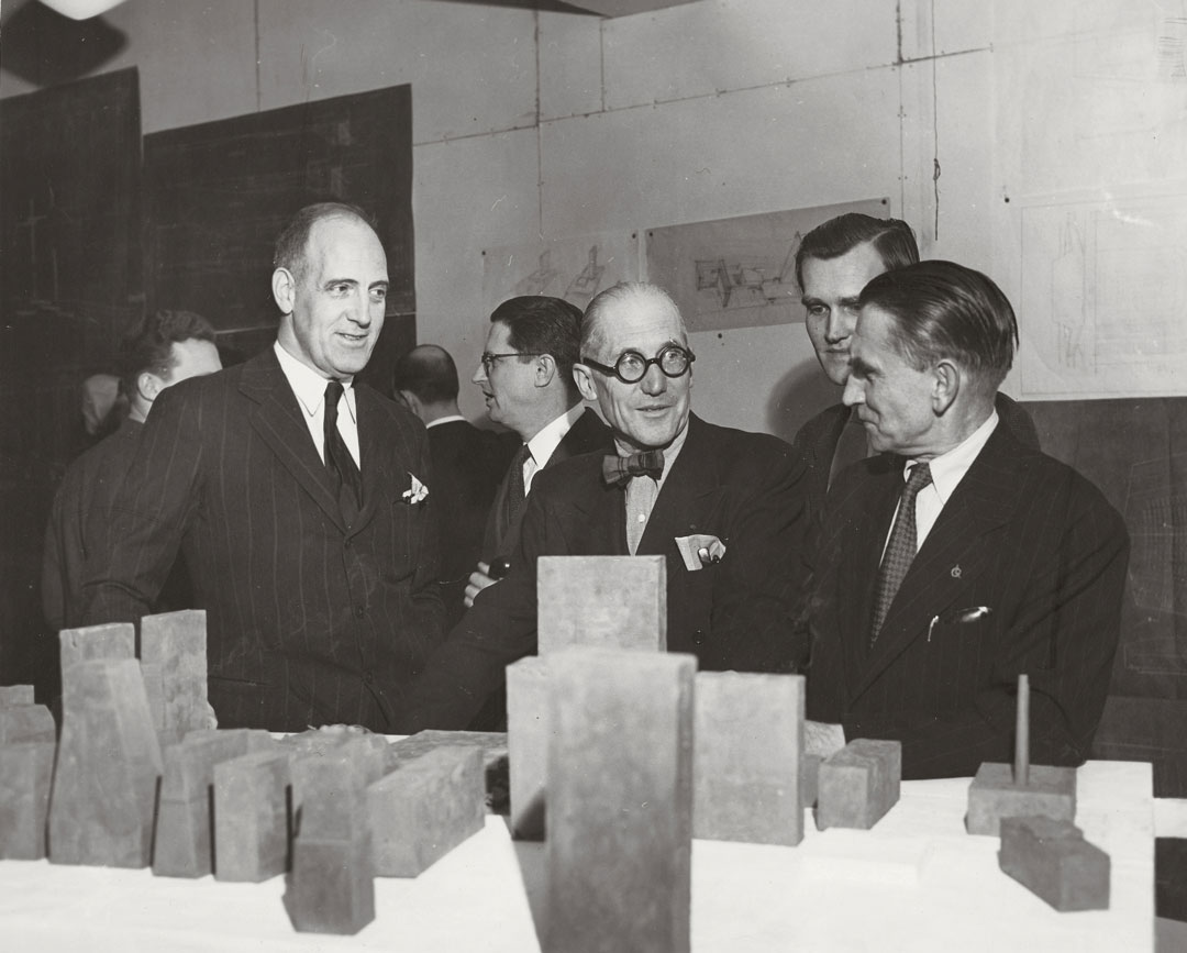 Le Corbusier, standing behind a display of models for the UN complex with Wallace K. Harrison (left) and Vladimir Bodiansky (right), 1947. Picture credit: courtesy Fondation Le Corbusier, Paris. As reproduced in Le Corbusier Le Grand
