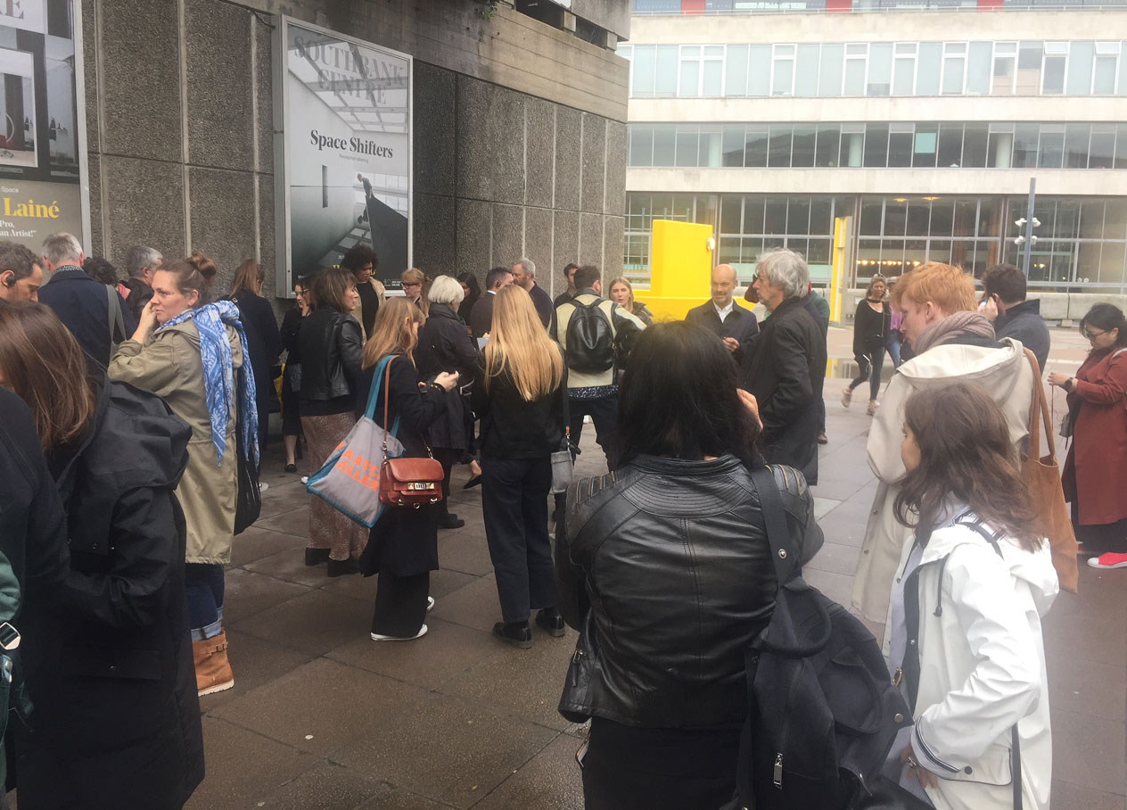 Brutal bus tour guests gather on the South Bank